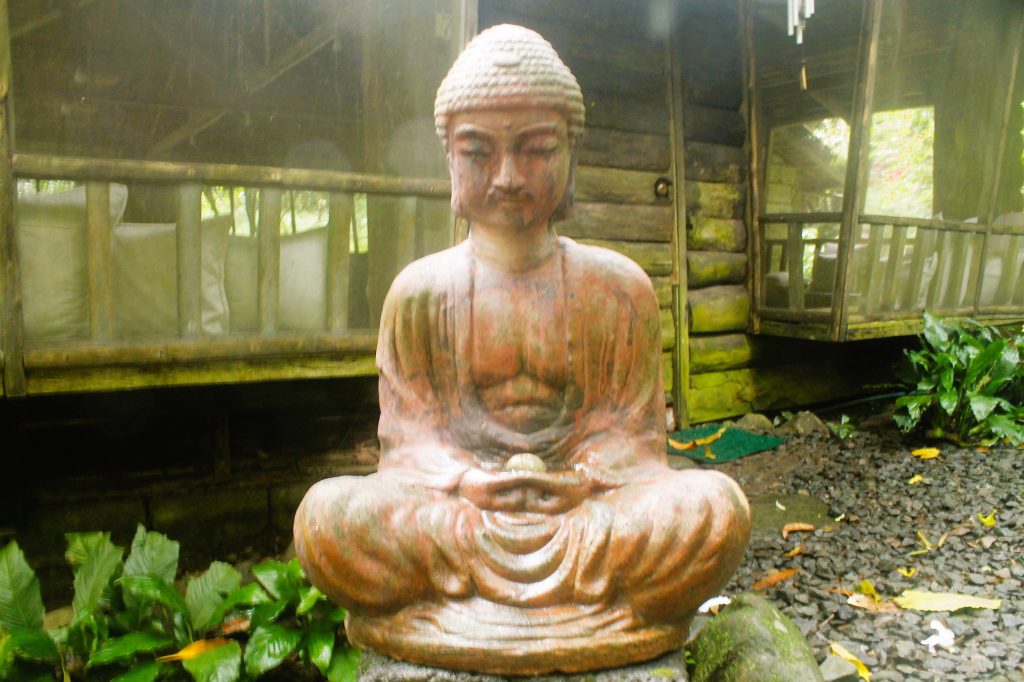 sitting-buddha-statue-with-cabin-in-background-at-camp-explore