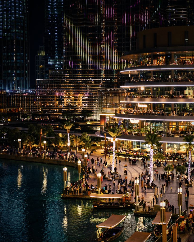 crowded-outdoors-of-a-well-lit-building-with-a-lake-in-front-dubai