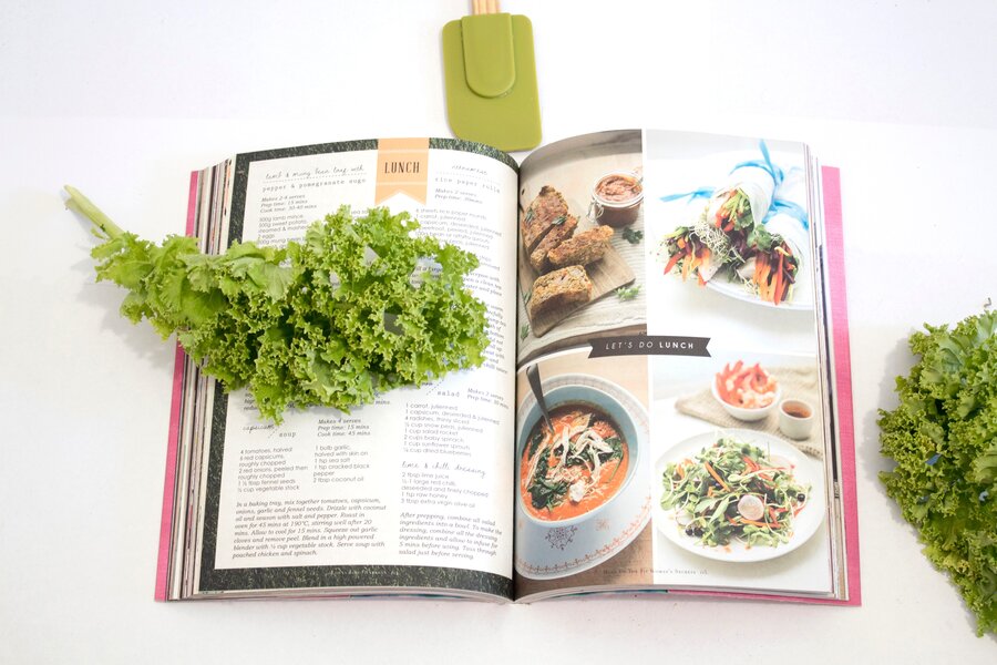 eat-well-recipe-book-pages-opened-with-green-leafy-vegetables-on-top